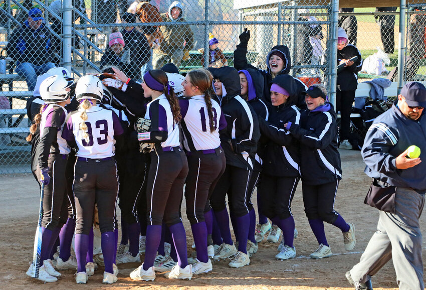 The Blair Bears swarm Laynie Brown at the plate after the sophomore's third-inning home run against Seward on Oct. 16 in Hastings.