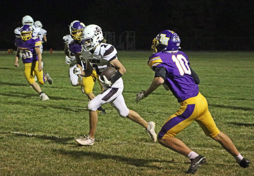 Arlington back Dallin Franzluebbers, middle, makes a cut inside and runs upfield Friday at Tekamah-Herman. The Eagles bested the Tigers for their third win of the season.