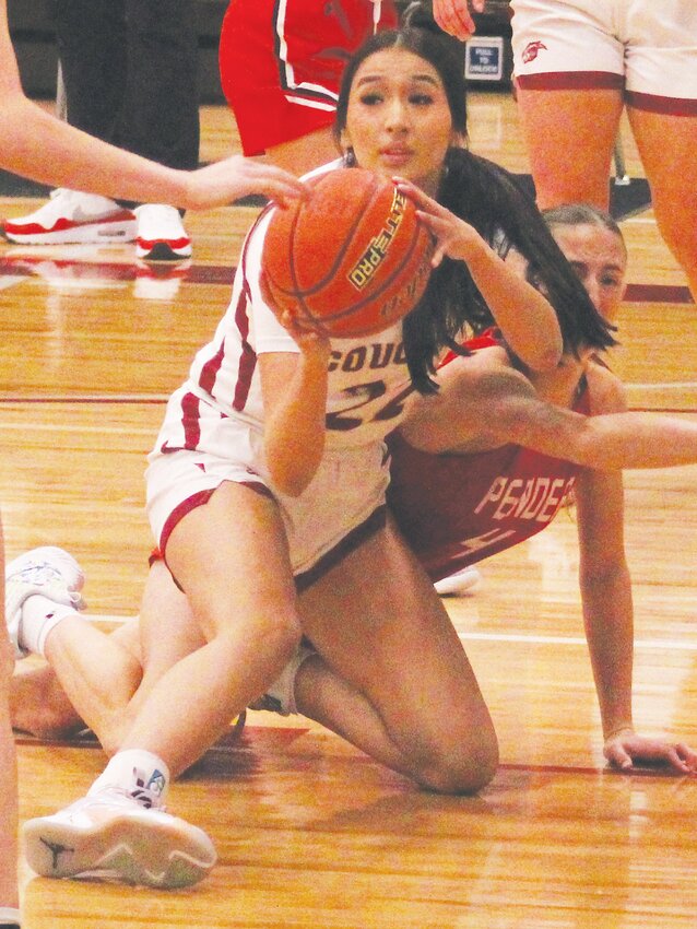 Getting control of the loose ball, Tavyanna Parker looks to pass against Pender.