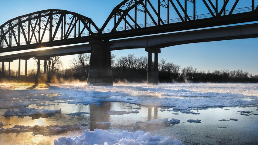 The morning sun peaks through the bridge frame and reflects off the Missouri River and ice flows on this week's frigid Tuesday morning. This was the view from the boat dock at Optimist Park in Blair.