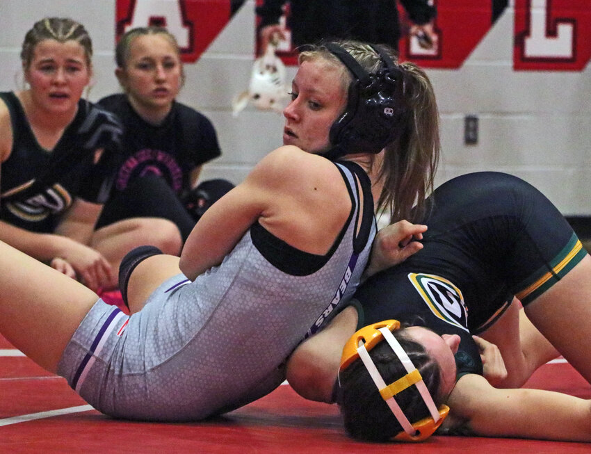 Blair wrestler Ali Wheeler, left, wrenches her Gretna opponent's arm into a pin Saturday during the Eastern Midlands Conference Tournament at Elkhorn High School.