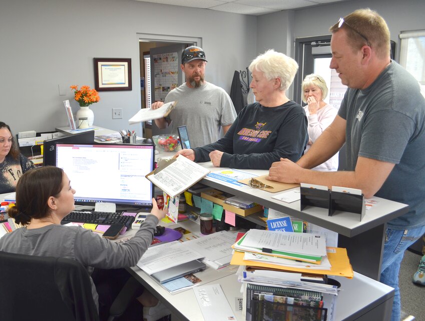 Sandy Givens submits a 16-page list of signatures to Fort Calhoun City Clerk Alicia Koziol on Monday afternoon. The petition calls for a special election to require a public vote on a proposed Omaha Police Department gun range east of the Fort Atkinson State Historical Park.
