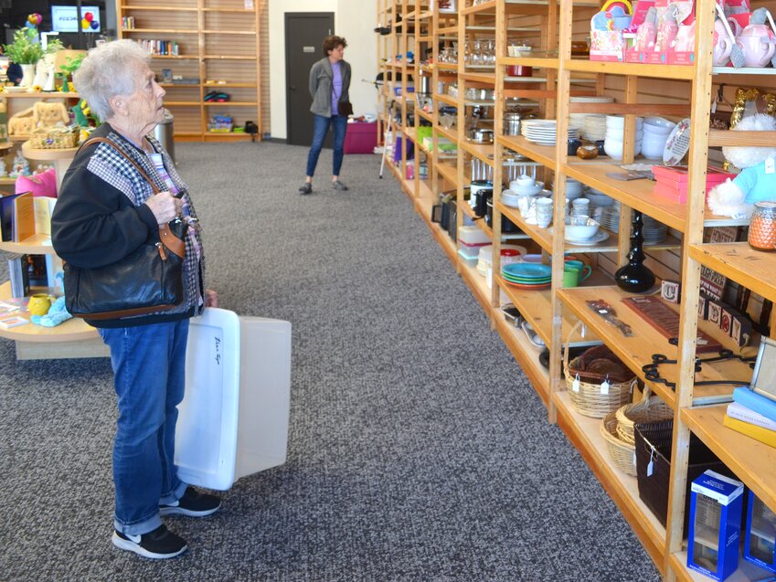 Long-time shopper Joan Ward scans the shelves for Easter decorations at the newly renovated Joseph Coat thrift store in Blair last week.