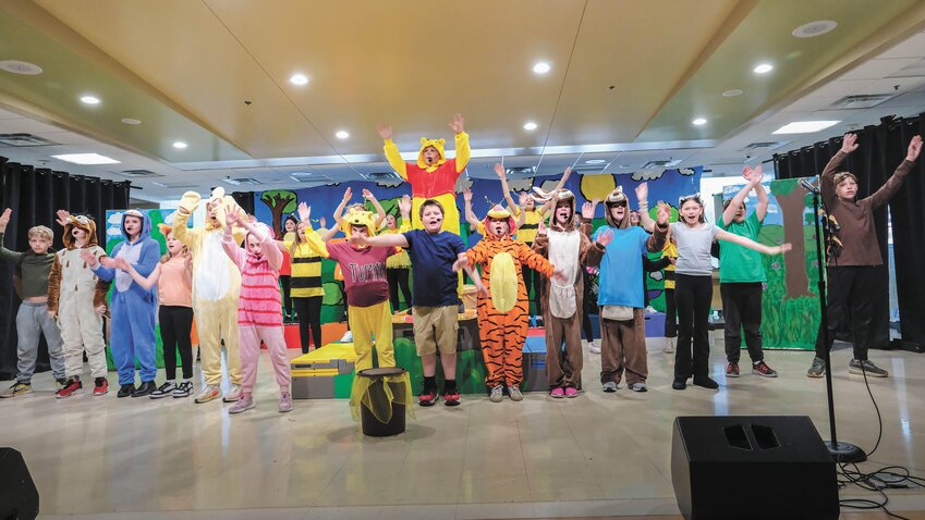 Christopher Robin (center), played by Arbor Park student Ryker Jennings, explains to Winnie the Pooh and friends the note he had left for the animals.
