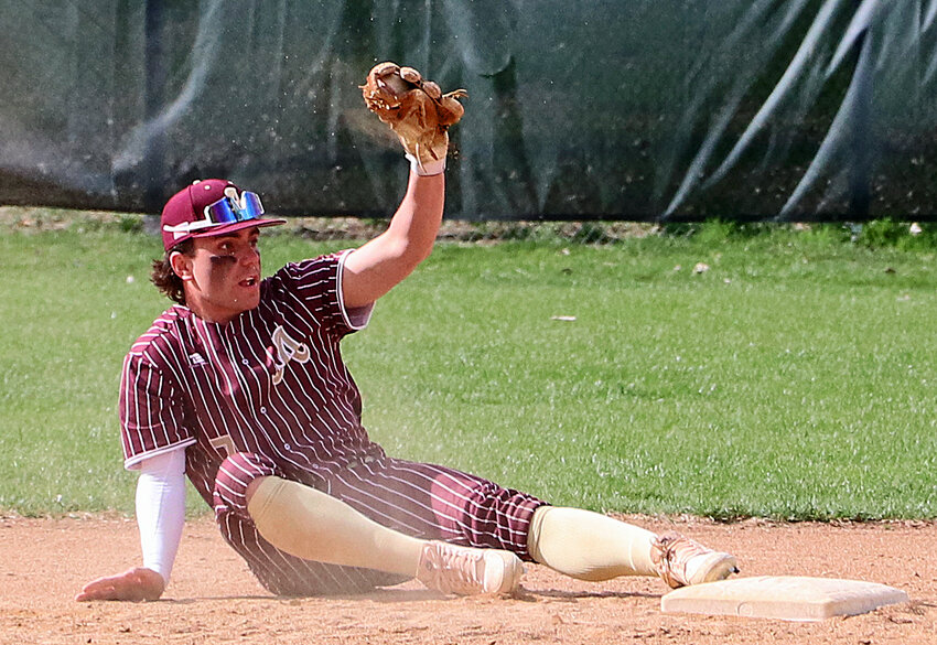 Arlington second baseman Tim Halley shows an umpire the ball Monday at the Washington County Fairgrounds.