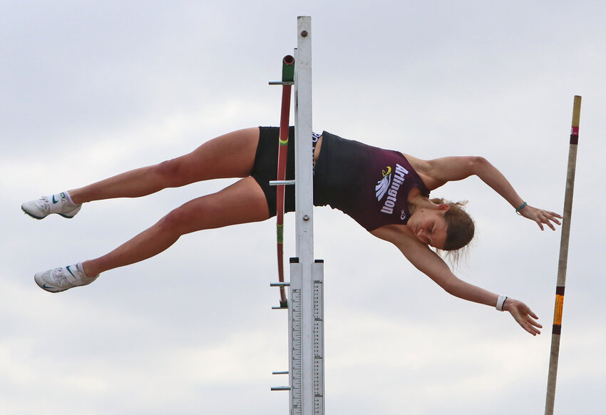 Arlington's Whitney Wollberg successfully clears the pole vault bar Thursday at Waverly High School.