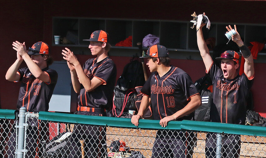 Fort Calhoun Pioneers celebrate in the dugout as their team scores runs Tuesday at the Washington County Fairgrounds. FCHS moved to 2-0 against the Arlington Eagles this season.