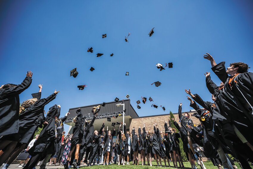 Members of the Fort Calhoun High School Class of 2025 toss their mortarboards in the air after last Saturday's commencement ceremony.