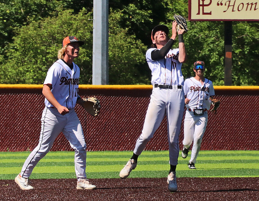 Fort Calhoun senior Sam Genoways, middle, gloves the game-ending popout as Chase Bierman, left, and Eli Tinkham watch Saturday at Fricke Field in Papillion.