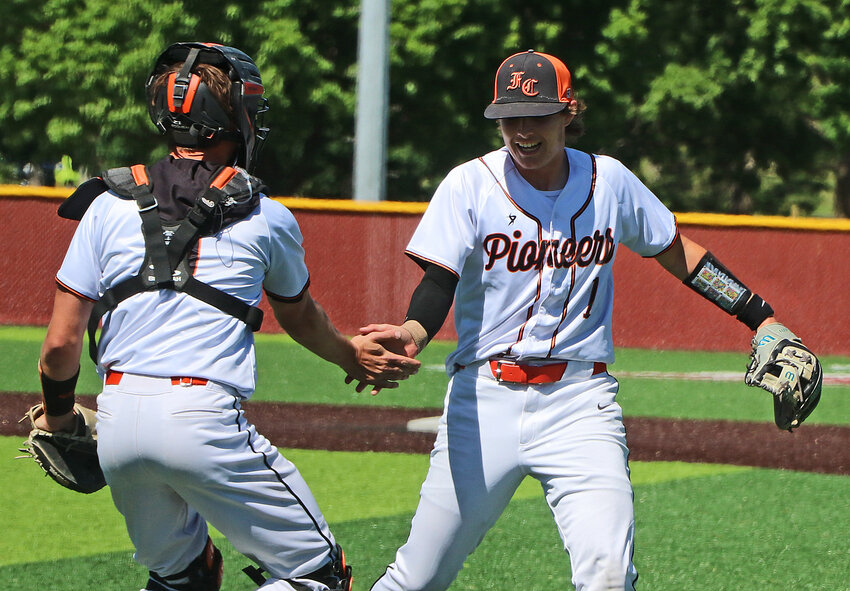 Fort Calhoun seniors Chase Premer, left, and Kenny Wellwood celebrate a Class C state baseball win Saturday at Fricke Field in Papillion.