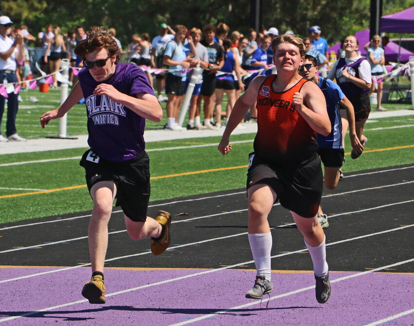 Blair's Caden Finken, left, and Fort Calhoun's Will Maxon race to the finish line May 13 during the district track meet at Krantz Field. Both Unified runners next compete at the NSAA State Championships in Omaha.