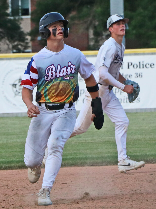 Blair Senior Legion base runner Hudson Hamm, left, watches a pop fly alongside a Platte River Rivals infielder June 4 at Vets Field.