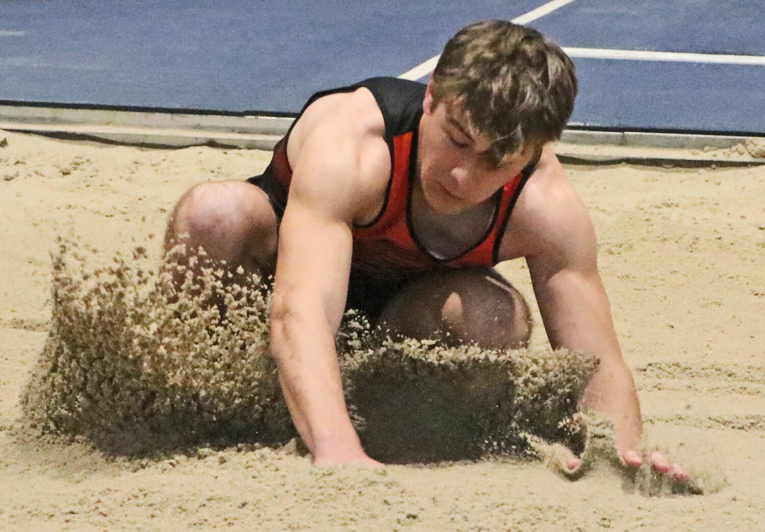 Fort Calhoun's Preston Johnson hits the long jump sand Friday in Omaha.