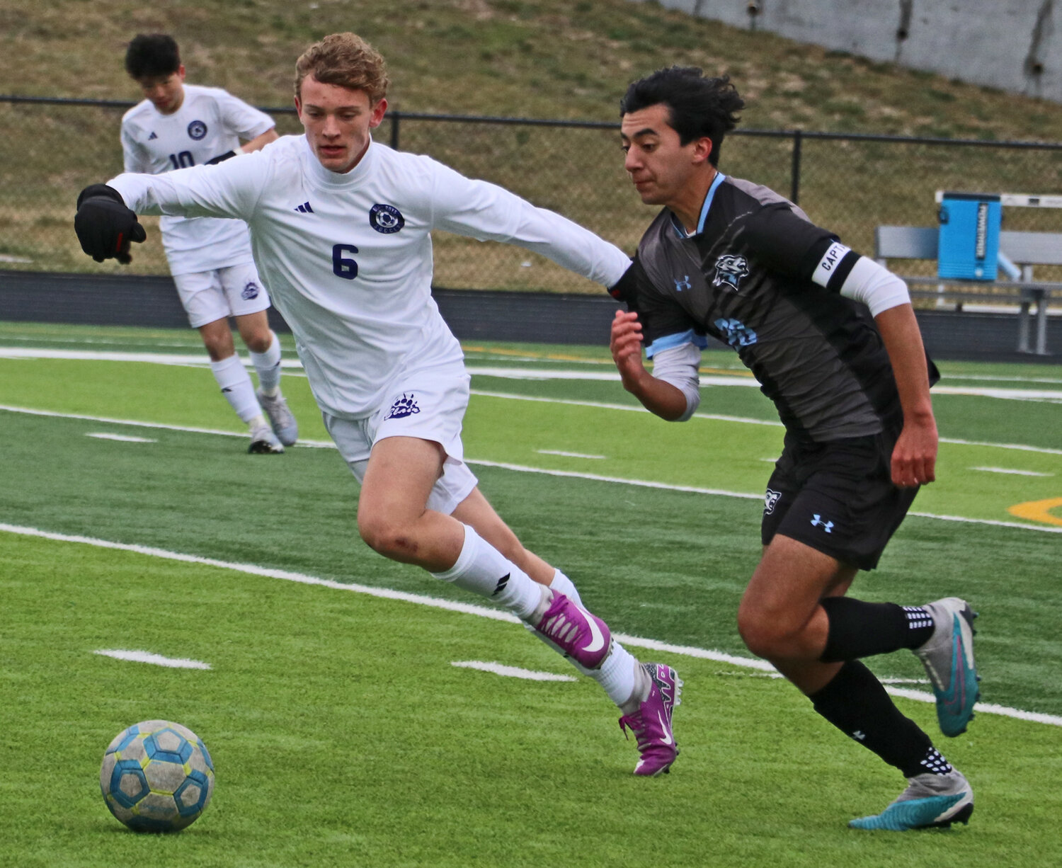 Blair's Alex Just, left, gives chase as the Wolves' Luke Grigsby dribbles upfield Monday at Elkhorn North. The No. 6 Wolves beat the Bears, 5-0, in the cold.