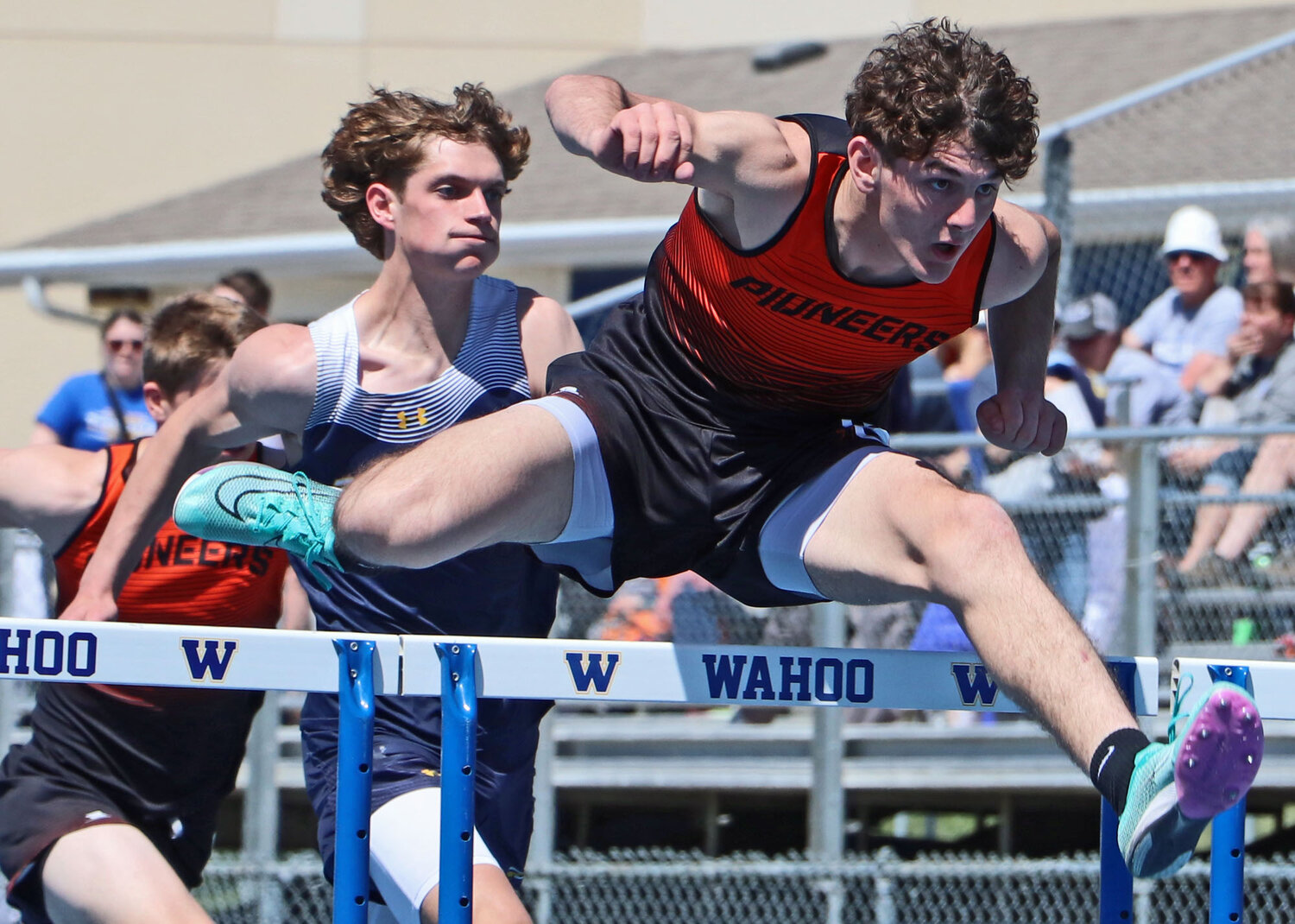 Matthew Kelly of Fort Calhoun clears a hurdle Friday at Wahoo High School. Arlington, Blair and the Pioneers all competed there during the Warriors' home meet.