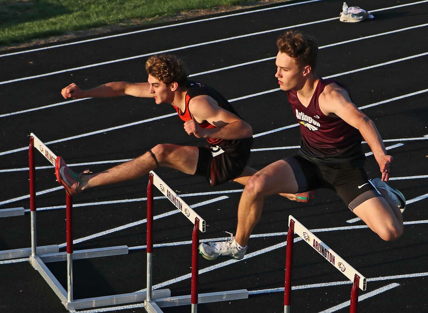 Fort Calhoun's Matthew Kelly, left, and the Eagles' Dallin Franzluebbers compete during the 300-meter hurdles on Thursday at Arlington High School.