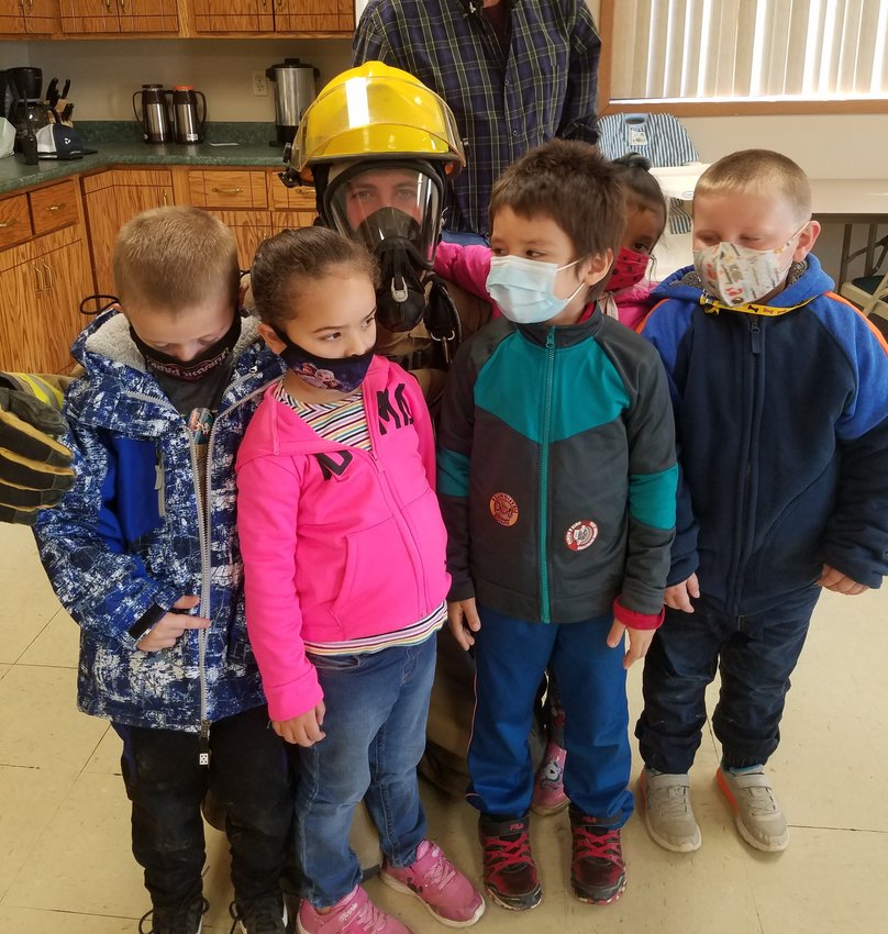 Iroquois elementary school students visited the fire station last week for fire prevention week. They learned about fire safety and toured the fire trucks. Students shown with firefighter Matthew Penner are  preschoolers Christopher Dorris, left, Elienai Hernandez, Enrique Siu Hansen, Sarai Hernandez and Nathan Wipf.
