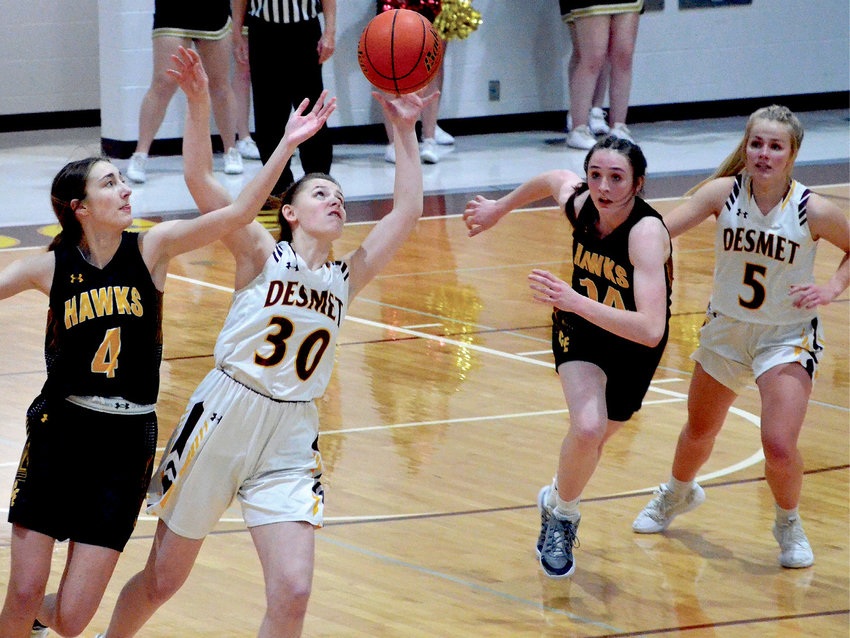 De Smet&rsquo;s Ella Poppinga (30) and Colman-Egan&rsquo;s Hailey Larson (4) fight for control of the ball Jan. 29 at De Smet, while Josie Mousel (14) and Emma Albrecht (5) are ready to assist.