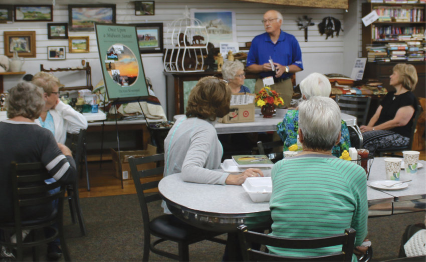 The audience listens intently as Delmer Wolkow talks about his little sister, DeAnn Kruempel, seated to his left in the black top, and the books she has written. Kruempel was in town last Friday for a book signing hosted at Ward&rsquo;s Store and Bakery.