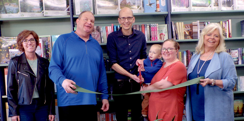 At noon, the Chamber of Commerce was on hand at the De Smet Mercantile and Coffeehouse for their ribbon cutting. Amy Kruse, left, Chad Kruse, Arthur, Lucas and Reena Lampinen and Rita Anderson took part in the celebration, with Lucas and Arthur cutting the ribbon.