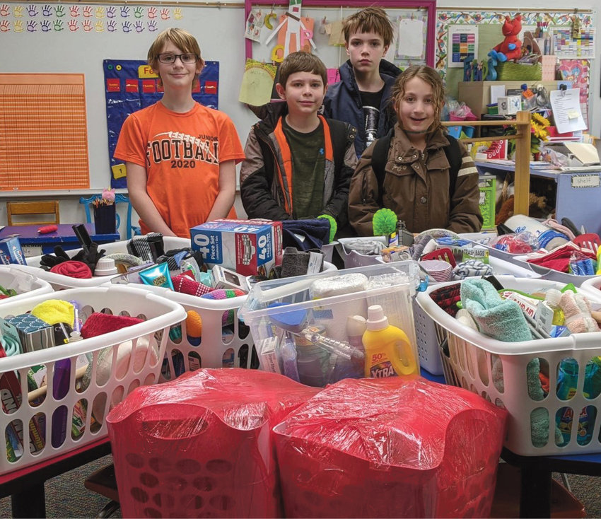 The Iroquois Elementary Student Council collected donations to compile 14 Buddy Baskets for homeless and needy veterans in the local community. These Buddy Baskets were presented to the Iroquois American Legion Auxiliary Unit 280 for distribution on Feb. 28. Items included are blankets, towels, toilet paper, paper towels, dish soap, laundry soap, hand soap and much more. Pictured are Connor Dant, left, Zachary Almont, Emmet McDermott and Nataley Wendel.&nbsp;Not pictured are Emma Lynn Elliot and Patience White.&nbsp;