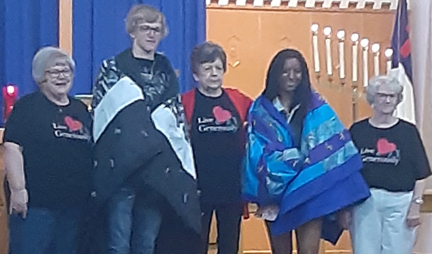 Three seniors recently received quilts at Sunday morning services at Oldham Lutheran Church. Milliana Waikel from Lake Preston High School and Wyatt Bickett of Oldham-Ramona High School were presented the gifts by the Quilt Ladies from the church. Not pictured was Bobbie Waikel of Oldham-Ramona High School.