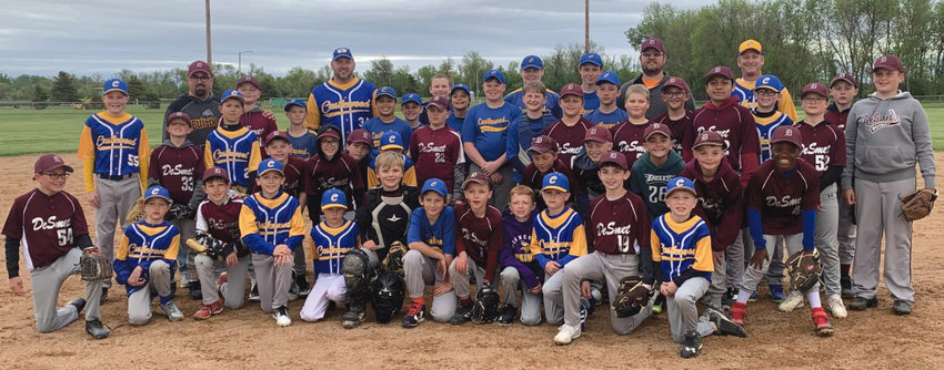 The De Smet and Castlewood boys 10U and 12U baseball teams join for a group photo after the De Smet boys presented a surprise check for $2,279 to help the Castlewood community with damage following a tornado.