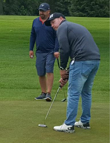 Mike Tordoff getting ready to putt with partner Terry Schmidt on hole nine.