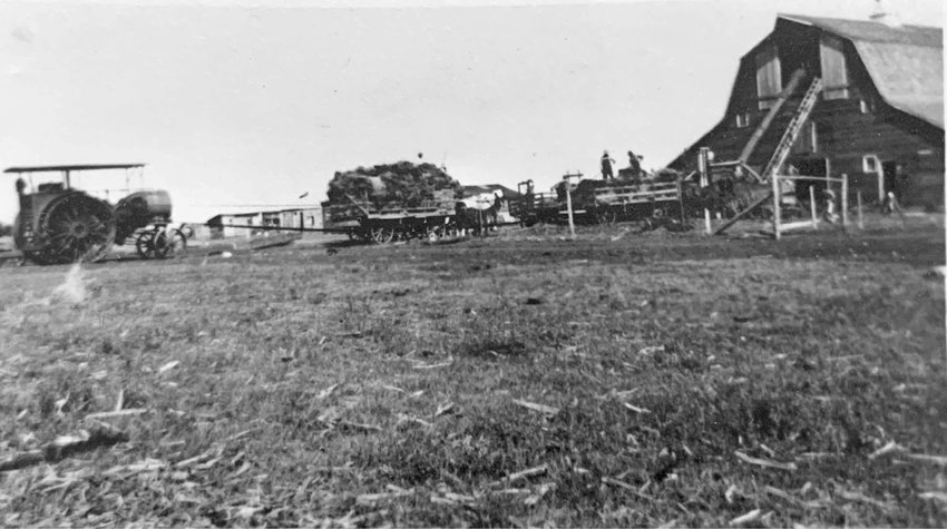 Pictured is the site of Sana in the 1880&rsquo;s. This picture is of the Lorenz brothers threshing for Les Clendening. They were blowing straw into the haymow and elevating grain into the barn at the same time. The tractor is a Twin Cities Tractor. Picture taken in 1927-1928.