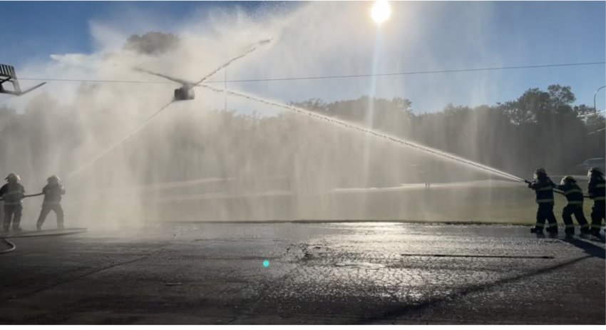 On Monday night, local firefighters practiced pumping water and hose control skills while engaged in a water war. They competed in groups of three to move the suspended barrel to the opponents' end of the cable line.