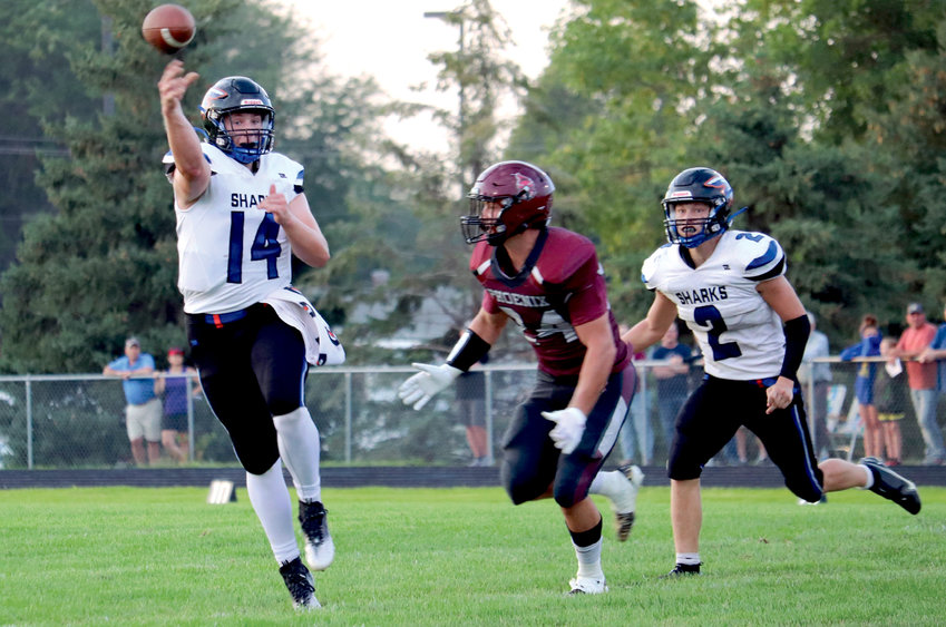Iroquois/Lake Preston's Logan Peskey (14) throws on the run Friday night in Freeman. In the first meeting between the two new co-op teams, the FMFA Phoenix defeated the Sharks 44-8.