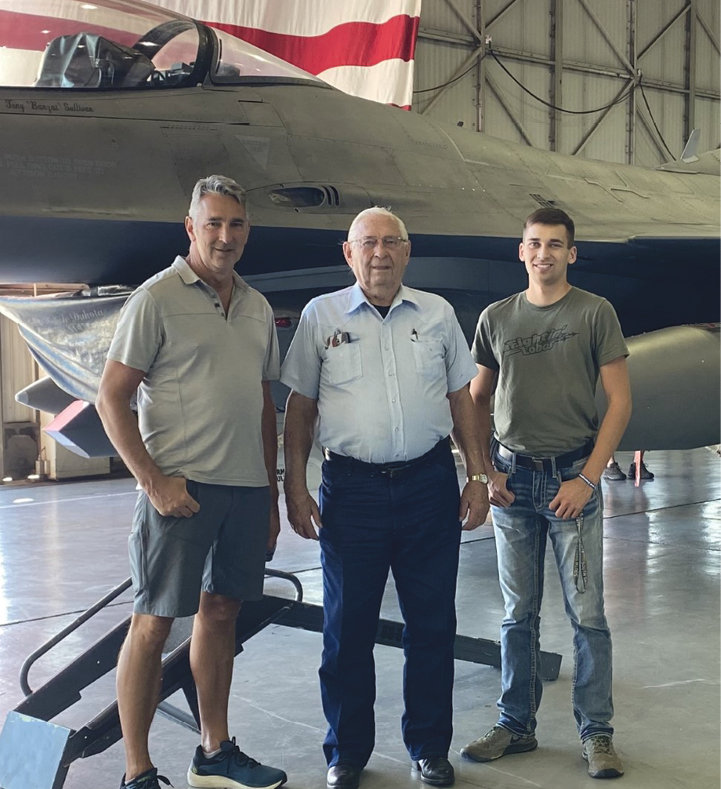 Hank Albrecht (center) flanked by his son and Honor Flight &ldquo;guardian&rdquo; Mike Albrecht (left) and his grandson Daniel Albrecht (right.)