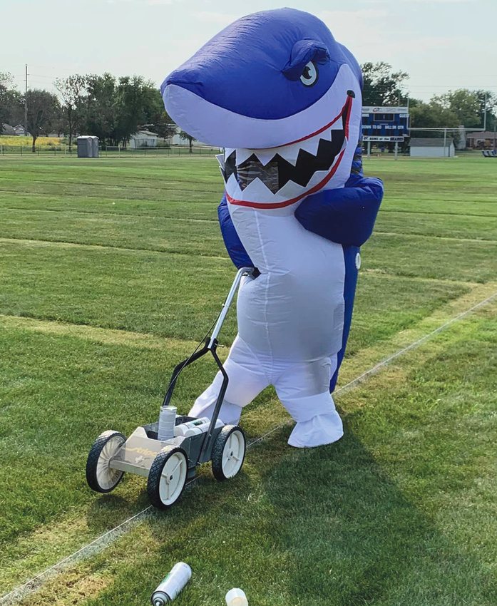 The Iroquois/Lake Preston football team took to the field for the first time as the Sharks. The mascot takes lawn care seriously, so he took care of those straight lines himself!