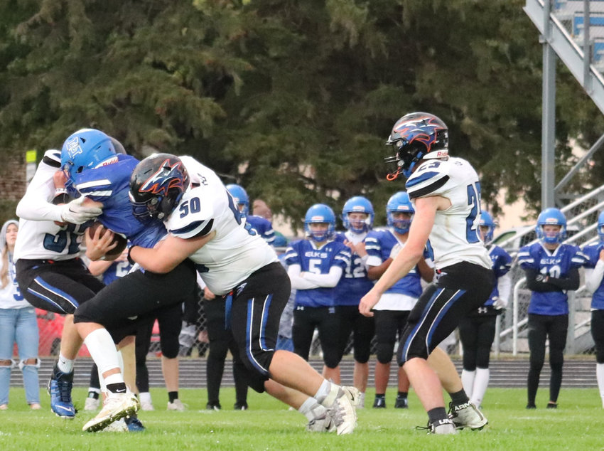 Ryne Greene and Riley Casper team up for the tackle Friday night as Jake Larsen looks to assist.