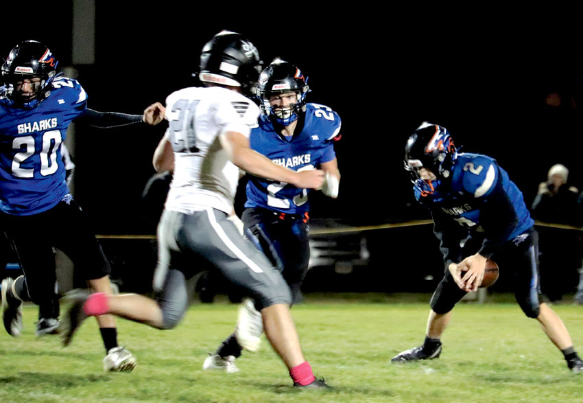 I/LP Sharks Ben Curd #20 and Jake Larsen #23 look to create a hole in the O-R/R defense Friday night as Hayden Shurson #2 gets ready to rush the ball.