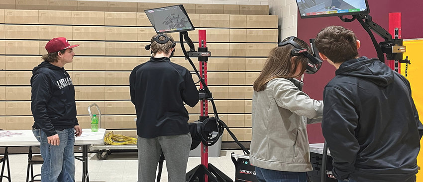 Lake Area Tech students Taylor Seifert and Tate Flaskey supervise two high school students, while they try the virtual welding training simulator at the Mini-Maker camp held Nov. 15, 2022, at De Smet High School.