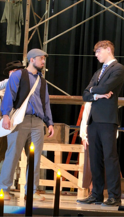 Garret Kruger as Jack and Bergan Woodcock as Mr. Pulitzer discussing paper price.