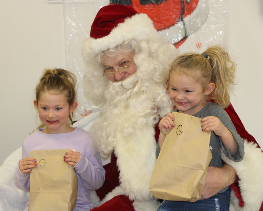 Jaiden Coughlin, left, and Macyn Coughlin, children of Scott and Erica, met with Santa at Carthage on Saturday.