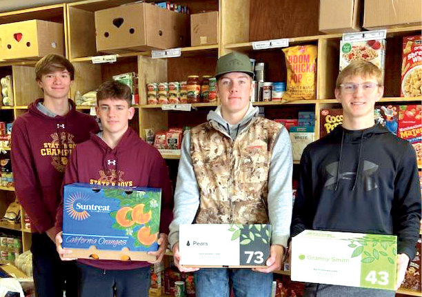 The FFA chapter donated the extra fruit from the fruit sales to the food pantry. This picture was taken when the fruit was delivered on Tues., Dec. 20. Pictured are George Jensen, left, Tom Aughenbaugh, Trace Van Regenmorter and Kadyn Fast.