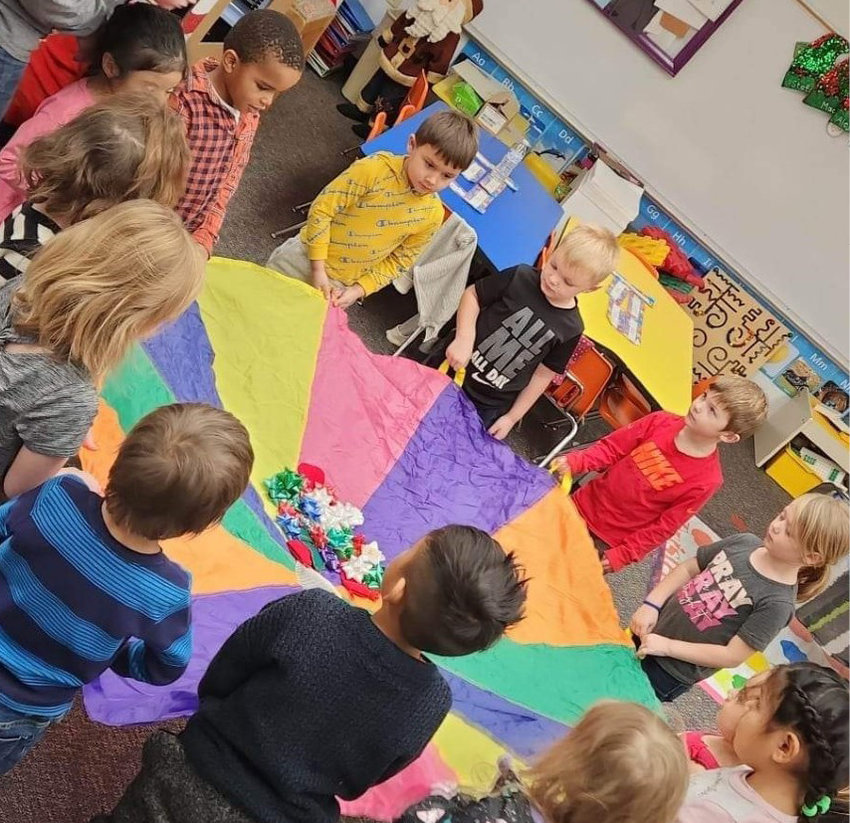 One Iroquois preschool Christmas party game included tossing ribbons, jingle bells, stockings and Christmas pompoms into the air with a parachute. There was an abundance of squeals and laughter!