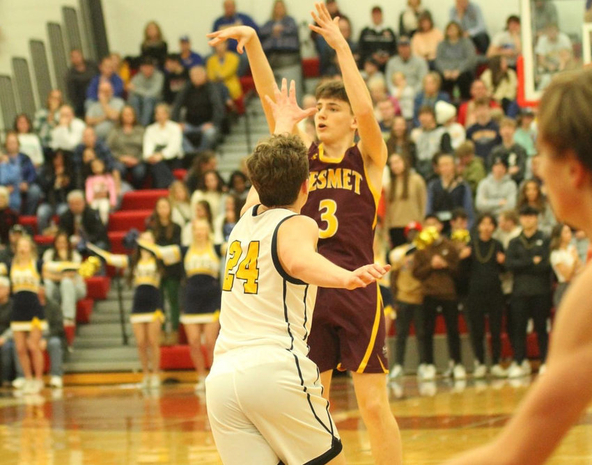 De Smet's Tom Aughenbaugh (3) puts up one of his four three-pointers on the night, as Sioux Valley's Oliver Vincent (24) scrambles to cover in front of a packed crowd at the Entringer Classic on New Year's Eve. Damon Wilkinson led De Smet with 27 points.