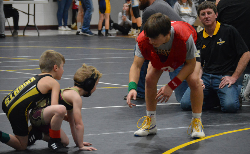 De Smet Youth Wrestling held its annual tournament Friday night; approximately 250 wrestlers participated. Gannon Gilligan referees Kingsbury County youth wrestler Ryder DeJong as coach Bryan Pietig looks on.