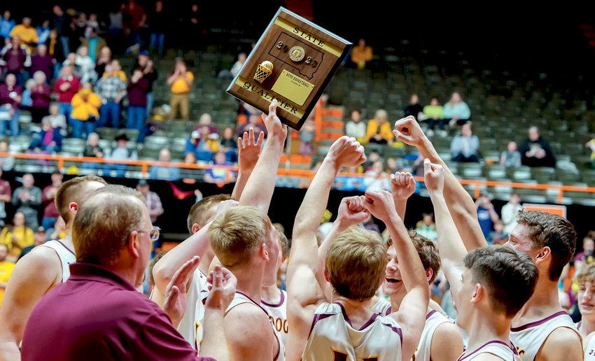 The De Smet Bulldogs hoist the SoDak 16 trophy after qualifying for the State B tournament with an 89-54 win over the Crazy Horse Chiefs on Tues., Mar. 7 at the Huron Arena.