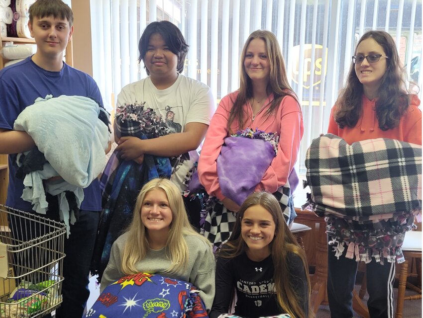 De Smet High School service learning students, Josh Siefert, back left, Willem Lim, Mia Yockey, Sophia Barr; Alyssa Asleson, front left, and Mirra Beck, show off handmade tie blankets made as a class project to donate to the De Smet Food Pantry.
