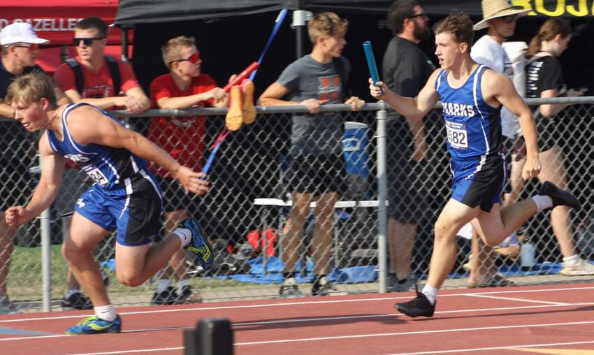 The Iroquois/Lake Preston Sharks competed at the South Dakota State Track &amp; Field Meet on May 25-27, 2023, at Howard Wood Field in Sioux Falls, S.D. Nathan Enninga prepares to give the baton to Jake Larsen during the sprint medley.