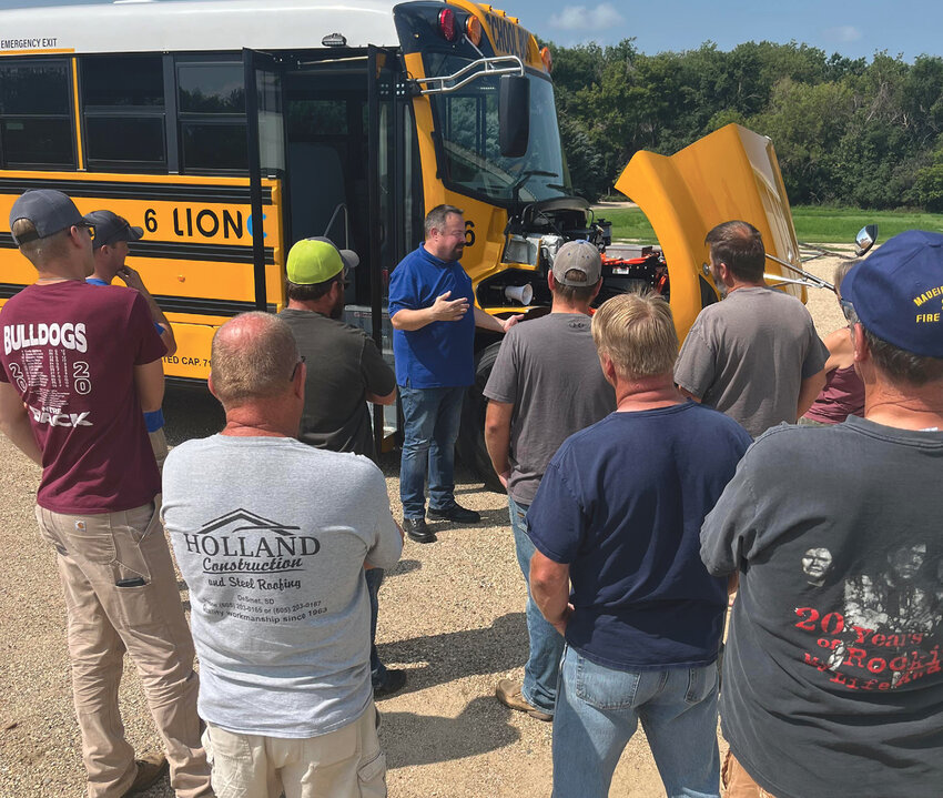 Steve Smith with Lion Bus Company discussed electric vehicle safety with De Smet Fire and Rescue Team members. The De Smet School District used federal grant money to purchase an electric bus for the 2023-24 school year.