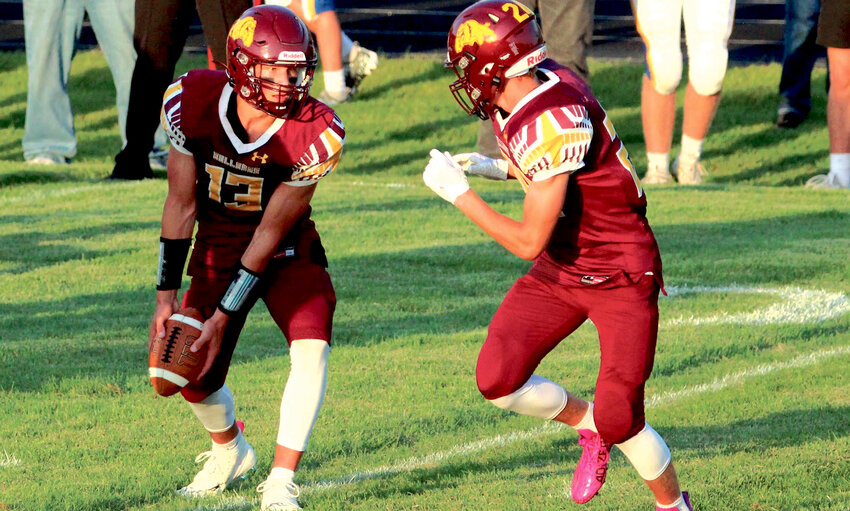 Bulldog quarterback Britt Carlson pitches the ball to Kadyn Fast during De Smet's 40-12 win over Castlewood on Friday night.