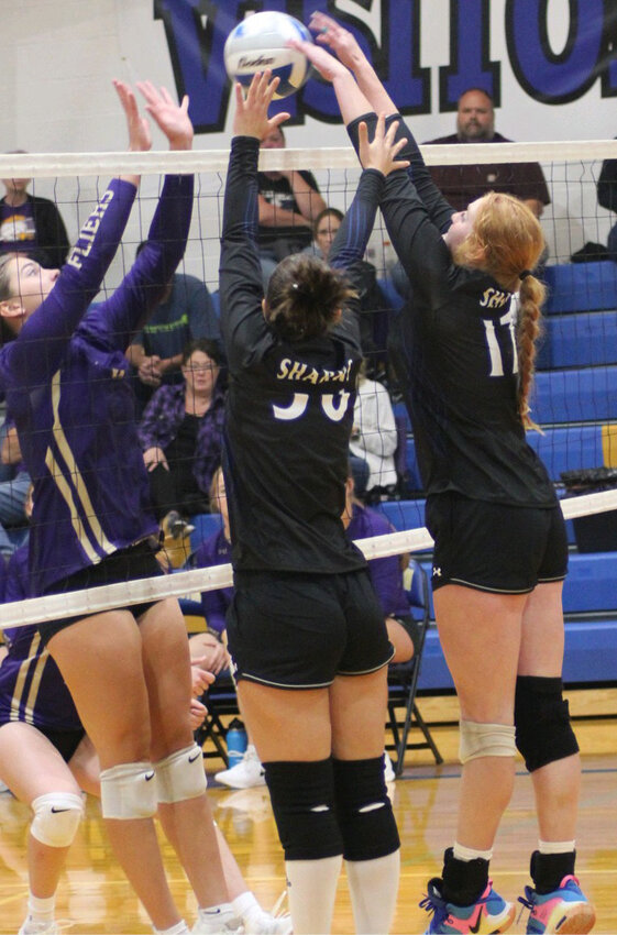 Elena Campagnolo and Hadlee Holt go up for a block against a Flandreau Flyer during the 44th Annual volleyball tournament.