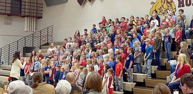 The De Smet school held a Veterans Day program on Friday to honor all who served. Above left: The elementary choir sang a song called &quot;Grateful to be American.&quot;