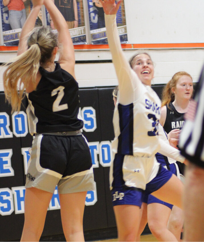 Rebecca Bich goes up to defend a shot against the Raiders during the season opener in Iroquois.